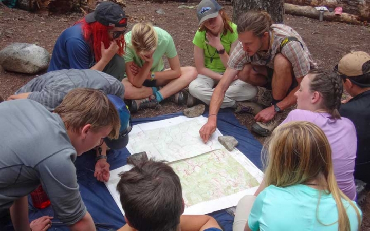 teens learning navigation on backpacking trip